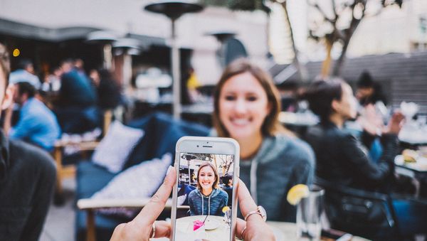 A person taking a photo with an iPhone - Sputnik International