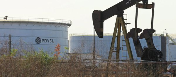 An oil pumpjack and a tank with the corporate logo of state oil company PDVSA are seen in an oil facility in Lagunillas - Sputnik International