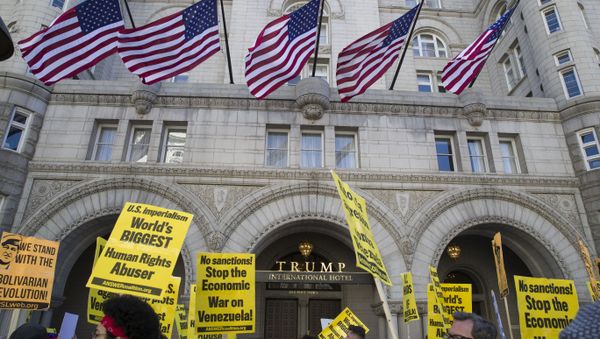 Activists walk past the front of the Trump International Hotel during the, Hands Off Venezuela!, 16 March, 2019, Washington - Sputnik International