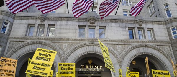 Activists walk past the front of the Trump International Hotel during the, Hands Off Venezuela!, 16 March, 2019, Washington - Sputnik International
