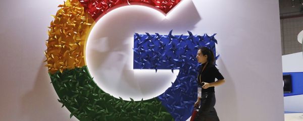 In this Monday, Nov. 5, 2018, photo, a woman carries a fire extinguisher past the logo for Google at the China International Import Expo in Shanghai In this Monday, Nov. 5, 2018, photo, a woman carries a fire extinguisher past the logo for Google at the China International Import Expo in Shanghai - Sputnik International