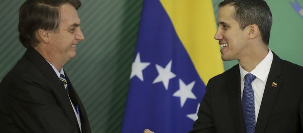Brazil's President Jair Bolsonaro, left, and Venezuela's self-proclaimed interim president Juan Guaido shake hands, Brasilia, Brazil, Thursday, Feb.28 - Sputnik International