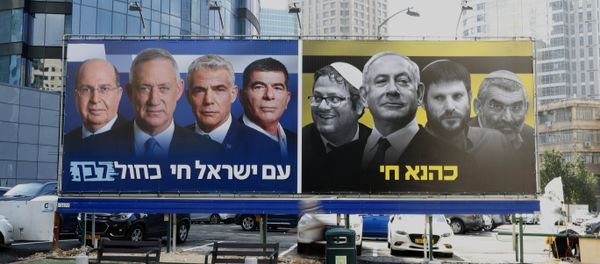 A picture taken on March 17, 2019 in the Israeli city of Ramat Gan in the suburbs of Tel Aviv shows a billboard bearing portraits of Blue and White (Kahol Lavan) political alliance leaders Moshe Yaalon, Benny Gantz, Yair Lapid and Gabi Ashkenazi, with a caption below reading in Hebrew The nation of Israeli lives; alongside another billboard showing Prime Minister Benjamin Netanyahu flanked by extreme right politicians Itamar Ben Gvir, Bezalel Smotrich and Michael Ben Ari, with another caption in Hebrew reading Kahana Lives in a reference to a banned ultranationalist party in the 1994. - Sputnik International