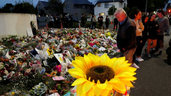 People visit a memorial site for victims of Friday's shooting, in front of the Masjid Al Noor mosque in Christchurch People visit a memorial site for victims of Friday's shooting, in front of the Masjid Al Noor mosque in Christchurch - Sputnik International