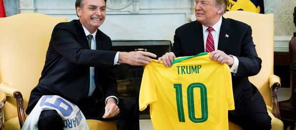 Brazil's President Jair Bolsonaro presents a Brazil naitonal soccer team jersey to US President Donald Trump after Trump gave him a US soccer team jersey during a meeting in the Oval Office of the White House in Washington, US, March 19, 2019. - Sputnik International