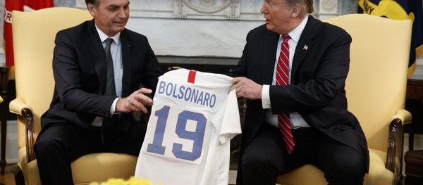 President Donald Trump presents Brazilian President Jair Bolsonaro with a U.S. national team soccer jersey during a meeting in the Oval Office of the White House, Tuesday, March 19, 2019, in Washington. (AP Photo/Evan Vucci) President Donald Trump presents Brazilian President Jair Bolsonaro with a U.S. national team soccer jersey during a meeting in the Oval Office of the White House, Tuesday, March 19, 2019, in Washington. (AP Photo/Evan Vucci) - Sputnik International