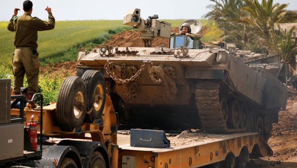 An Israeli soldier directs an armoured personnel carrier (APC) near the border between Israel and Gaza on its Israeli side, March 15, 2019 An Israeli soldier directs an armoured personnel carrier (APC) near the border between Israel and Gaza on its Israeli side, March 15, 2019 - Sputnik International