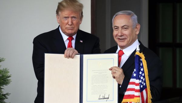 U.S. President Donald Trump and Israel's Prime Minister Benjamin Netanyahu hold up a proclamation recognizing Israel's sovereignty over the Golan Heights as Netanyahu exits the White House from the West Wing in Washington, U.S. March 25, 2019 - Sputnik International