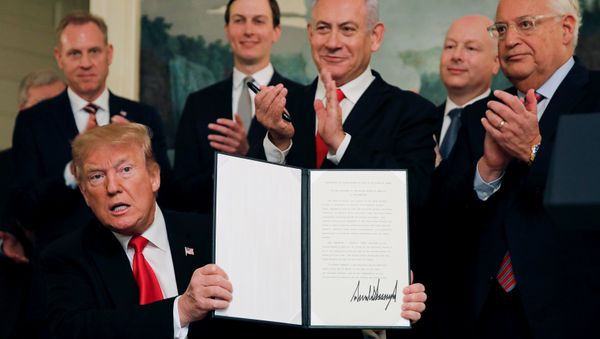 U.S. President Donald Trump holds a proclamation recognizing Israel's sovereignty over the Golan Heights as he is applauded by Israel's Prime Minister Benjamin Netanyahu and others during a ceremony in the Diplomatic Reception Room at the White House in Washington, U.S., March 25, 2019 - Sputnik International
