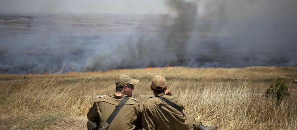Israeli soldiers sit in a position on the Israeli-controlled Golan Heights as smoke rises following explosions of mortar shells (File) Israeli soldiers sit in a position on the Israeli-controlled Golan Heights as smoke rises following explosions of mortar shells (File) - Sputnik International