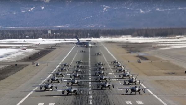 An elephant walk of 24 F-22 Raptor stealth fighters, a C-17 Globemaster III transport plane and an E-3 Sentry command and control surveillance craft take off from Alaska’s Joint Base Elmendorf-Richardson base March 26, 2019.  - Sputnik International