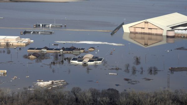 This March 17, 2019 photo released by the U.S. Air Force shows an aerial view of Offutt Air Force Base and the surrounding areas affected by flood waters in Neb. Surging unexpectedly strong and up to 7 feet high, the MissouriRiver floodwaters that poured on to much the Nebraska air base that houses the U.S. Strategic Command overwhelmed the frantic sandbagging by troops and their scramble to save sensitive equipment, munitions and aircraft. - Sputnik International