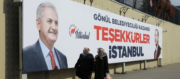People walk past by AK Party billboards with pictures of Turkish President Tayyip Erdogan and mayoral candidate Binali Yildirim in Istanbul, Turkey, April 1, 2019. People walk past by AK Party billboards with pictures of Turkish President Tayyip Erdogan and mayoral candidate Binali Yildirim in Istanbul, Turkey, April 1, 2019. - Sputnik International
