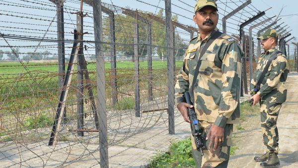 Indian Border Security Force personnel walk along a fence at the India Pakistan border on the outskirts of Amritsar on February 27, 2019 Indian Border Security Force personnel walk along a fence at the India Pakistan border on the outskirts of Amritsar on February 27, 2019 - Sputnik International