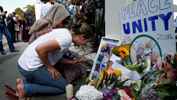 A woman cries next to a tribute to victim Hussein Al-Umari outside Al-Noor mosque after it was reopened in Christchurch, New Zealand, March 23, 2019 - Sputnik International