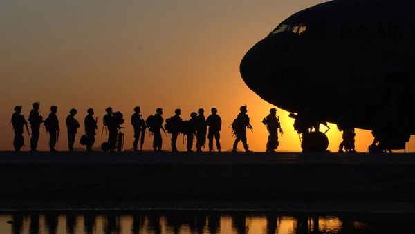 The sun sets behind a C-17 Globemasterat Joint Base Balad, Iraq, as Soldiers begin boarding The sun sets behind a C-17 Globemasterat Joint Base Balad, Iraq, as Soldiers begin boarding - Sputnik International