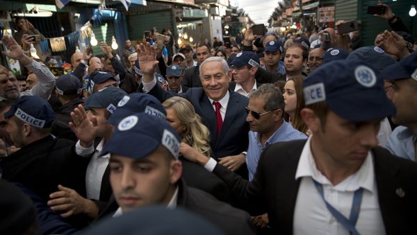 Israeli Prime Minister and head of the Likud party Benjamin Netanyahu, center, is escorted by security guards during a visit to the Ha'tikva market in Tel Aviv, Israel, Tuesday, April 2, 2019 Israeli Prime Minister and head of the Likud party Benjamin Netanyahu, center, is escorted by security guards during a visit to the Ha'tikva market in Tel Aviv, Israel, Tuesday, April 2, 2019 - Sputnik International