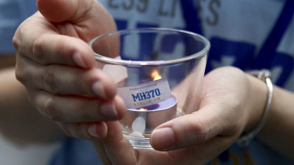 A family member of a passenger of Malaysia Airlines Flight 370, holds a candle during the Day of Remembrance for MH370 event in Kuala Lumpur, Malaysia, Sunday, March 3, 2019 - Sputnik International