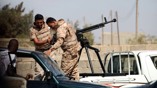 Soldiers from the Libyan National Army get ready to enter Rafallah al-sahati Islamic Militia Brigades compound, one of the compound buildings can be seen behind the wall, in Benghazi, Libya, Saturday, Sept. 22, 2012. Soldiers from the Libyan National Army get ready to enter Rafallah al-sahati Islamic Militia Brigades compound, one of the compound buildings can be seen behind the wall, in Benghazi, Libya, Saturday, Sept. 22, 2012. - Sputnik International