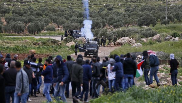 Palestinian protesters face Israeli troops during clashes following a demonstration in the village of Mughayir in the Israeli-occupied West Bank Palestinian protesters face Israeli troops during clashes following a demonstration in the village of Mughayir in the Israeli-occupied West Bank - Sputnik International
