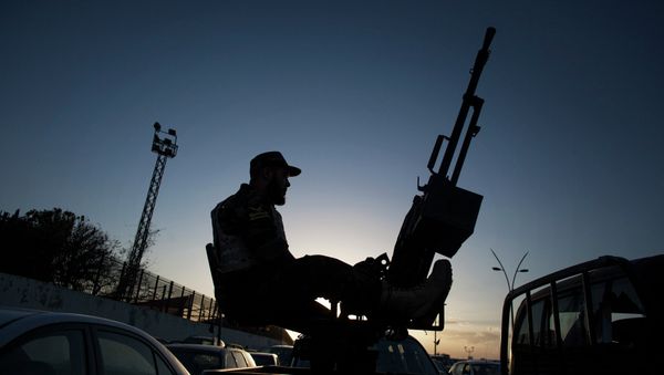 A Libyan army soldier stands guard sitting on an antiaircraft truck during the handover of the Nawaseen military compound, which was the headquarters of Libyan militias, in Souk al-Juma district, Tripoli, Libya A Libyan army soldier stands guard sitting on an antiaircraft truck during the handover of the Nawaseen military compound, which was the headquarters of Libyan militias, in Souk al-Juma district, Tripoli, Libya - Sputnik International