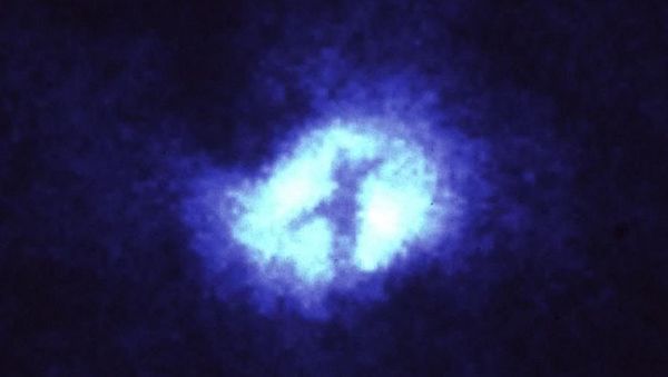 This image of the core of the nearby spiral galaxy M51, taken with the Wide Field Planetary camera (in PC mode) on the NASA/ESA Hubble Space Telescope, shows a striking , dark X silhouetted across the galaxy's nucleus - Sputnik International