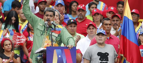 Argentina's former star player Diego Armando Maradona, right, listens to Venezuela's President Nicolas Maduro speaking during his closing campaign rally in Caracas, Venezuela, Thursday, May 17, 2018 Argentina's former star player Diego Armando Maradona, right, listens to Venezuela's President Nicolas Maduro speaking during his closing campaign rally in Caracas, Venezuela, Thursday, May 17, 2018 - Sputnik International