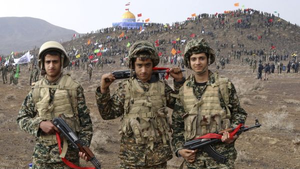 Nov. 20, 2015 photo released by the Fars News Agency, members of the Basij, the paramilitary unit of Iran's Revolutionary Guard, pose for a picture during a military exercise outside the holy city of Qom, central Iran - Sputnik International