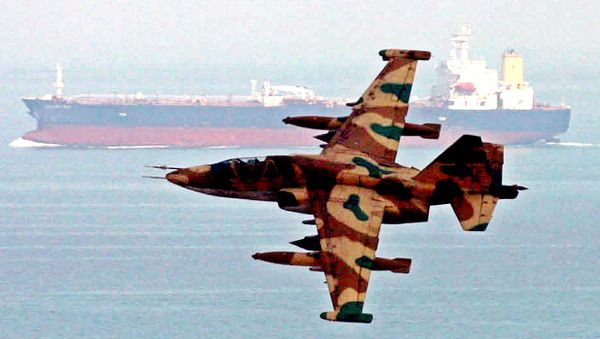 An aircraft of Iran's elite Revolutionary Guards,  flies over an oil tanker during  maneuvers in the Gulf and Sea of Oman, Wednesday, April 5, 2006. - Sputnik International