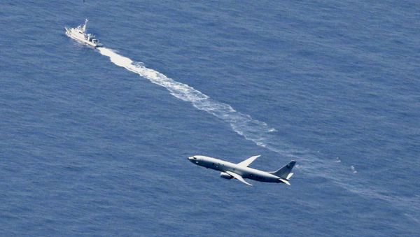 A Japan Coast Guard vessel and a U.S. military aircraft conduct rescue and search operations at the site where an Air Self-Defense Force's F-35A stealth fighter jet crashed during an exercise on April 9, 2019, off Aomori prefecture, Japan, in this photo taken by Kyodo April 10, 2019 - Sputnik International