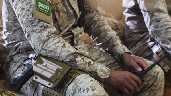 In this Wednesday, Nov. 28, 2018, photograph, an armed Saudi soldier holds a walkie-talkie near Mukalla, Yemen, at an airport now serving as a military base for the United Arab Emirates. In this Wednesday, Nov. 28, 2018, photograph, an armed Saudi soldier holds a walkie-talkie near Mukalla, Yemen, at an airport now serving as a military base for the United Arab Emirates. - Sputnik International