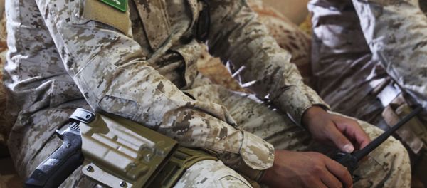 In this Wednesday, Nov. 28, 2018, photograph, an armed Saudi soldier holds a walkie-talkie near Mukalla, Yemen, at an airport now serving as a military base for the United Arab Emirates. In this Wednesday, Nov. 28, 2018, photograph, an armed Saudi soldier holds a walkie-talkie near Mukalla, Yemen, at an airport now serving as a military base for the United Arab Emirates. - Sputnik International
