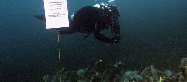 In this photo taken on Sunday, April 7, 2019, an archaeologists dives next ancient amphoras from a 5th Century B.C. shipwreck, the first ancient shipwreck to be opened to the public in Greece, including to recreational divers who will be able to visit the wreck itself, near the coast of Peristera, Greece. In this photo taken on Sunday, April 7, 2019, an archaeologists dives next ancient amphoras from a 5th Century B.C. shipwreck, the first ancient shipwreck to be opened to the public in Greece, including to recreational divers who will be able to visit the wreck itself, near the coast of Peristera, Greece. - Sputnik International
