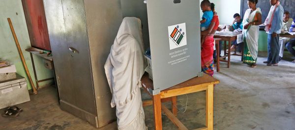 A woman casts her vote as others wait for their turn at a polling station during the first phase of general election in Majuli, a large river island in the Brahmaputra river, in the northeastern Indian state of Assam, India April 11, 2019 A woman casts her vote as others wait for their turn at a polling station during the first phase of general election in Majuli, a large river island in the Brahmaputra river, in the northeastern Indian state of Assam, India April 11, 2019 - Sputnik International