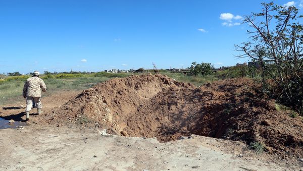 A crater is seen at the blast site after an air strike at Mitiga airport in Tripoli A crater is seen at the blast site after an air strike at Mitiga airport in Tripoli - Sputnik International