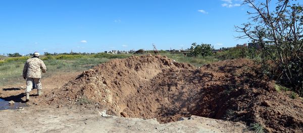 A crater is seen at the blast site after an air strike at Mitiga airport in Tripoli A crater is seen at the blast site after an air strike at Mitiga airport in Tripoli - Sputnik International