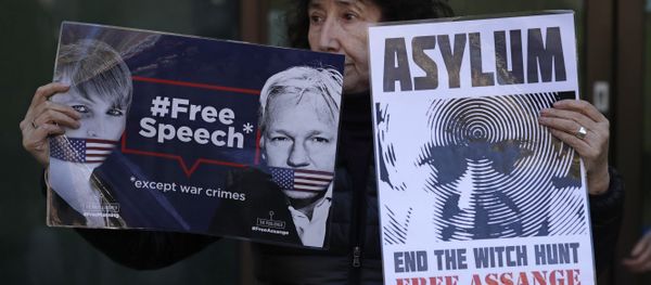 A protester demonstrating in support of WikiLeaks founder Julian Assange holds placards outside Westminster magistrates court where he was appearing in London, Thursday, April 11, 2019. A protester demonstrating in support of WikiLeaks founder Julian Assange holds placards outside Westminster magistrates court where he was appearing in London, Thursday, April 11, 2019. - Sputnik International
