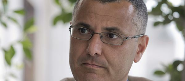 Omar Barghouti listens during an interview with the Associated Press in the West Bank city of Ramallah, Tuesday, May 10, 2016. Barghouti, a Qatari-born Palestinian who is married to an Israeli woman and leader of the international boycott movement against Israel, on Tuesday accused Israeli authorities of imposing a travel ban on him as retribution for his political activities. Omar Barghouti listens during an interview with the Associated Press in the West Bank city of Ramallah, Tuesday, May 10, 2016. Barghouti, a Qatari-born Palestinian who is married to an Israeli woman and leader of the international boycott movement against Israel, on Tuesday accused Israeli authorities of imposing a travel ban on him as retribution for his political activities. - Sputnik International