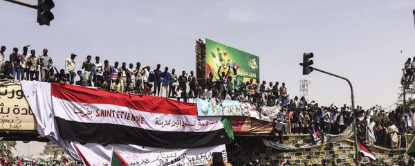Demonstrators gather in Sudan's capital of Khartoum, Friday, April 12, 2019. The Sudanese protest movement has rejected the military's declaration that it has no ambitions to hold the reins of power for long after ousting the president of 30 years, Omar al-Bashir. The writing on the Sudanese flag says With the participation of the Sudanese in Saint Etienne, France. - Sputnik International