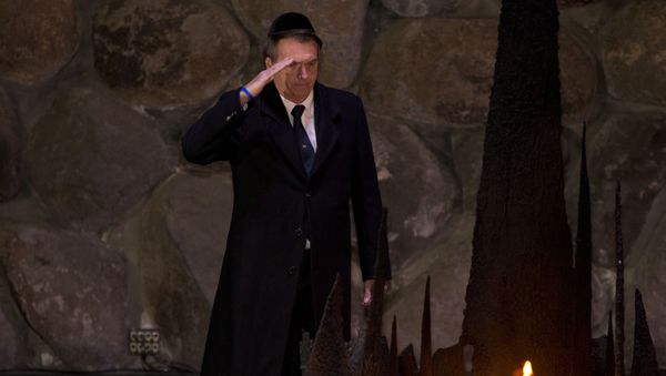 Brazil's President Jair Bolsonaro salutes during a ceremony commemorating the six million Jews killed by the Nazis during the Holocaust, in the Hall of Remembrance at Yad Vashem World Holocaust Remembrance Center Jerusalem, Tuesday, April 2, 2019. - Sputnik International