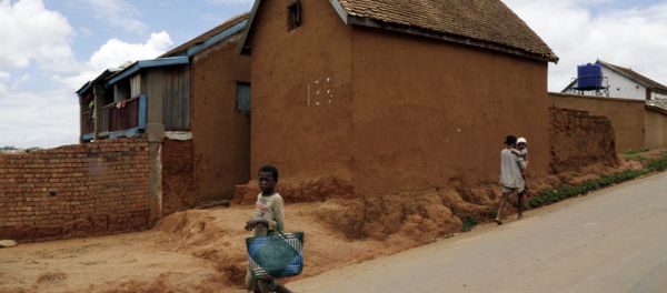 A young girl runs past a house in Antananarivo, Madagascar A young girl runs past a house in Antananarivo, Madagascar - Sputnik International