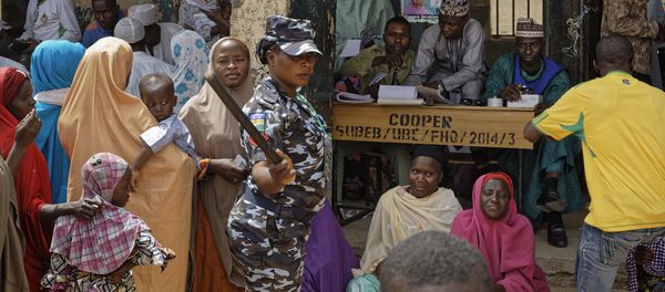 A policewoman chases away children as women queue in the midday sun to cast their votes at a polling station in Kano, northern Nigeria Saturday, Feb. 23, 2019. Nigerians are going to the polls for a presidential election Saturday, one week after a surprise delay for Africa's largest democracy. A policewoman chases away children as women queue in the midday sun to cast their votes at a polling station in Kano, northern Nigeria Saturday, Feb. 23, 2019. Nigerians are going to the polls for a presidential election Saturday, one week after a surprise delay for Africa's largest democracy. - Sputnik International