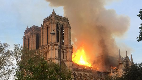 Fire engulfs the iconic Notre Dame cathedral in Paris. Fire engulfs the iconic Notre Dame cathedral in Paris. - Sputnik International