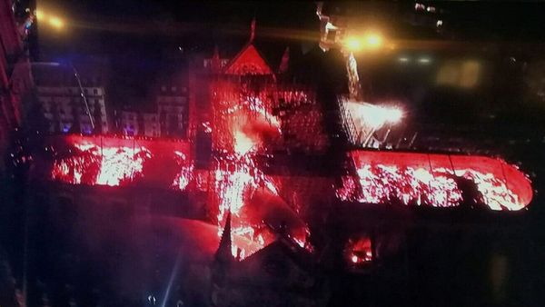 An image taken from a television screen shows an aerial view of the Notre Dame Cathedral engulfed in flames on 15 April, 2019, in the French capital Paris An image taken from a television screen shows an aerial view of the Notre Dame Cathedral engulfed in flames on 15 April, 2019, in the French capital Paris - Sputnik International