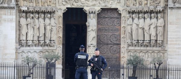 French police officers stand outside Notre-Dame-de Paris on 16 April, 2019 in Paris in the aftermath of a fire that devastated the cathedral French police officers stand outside Notre-Dame-de Paris on 16 April, 2019 in Paris in the aftermath of a fire that devastated the cathedral - Sputnik International