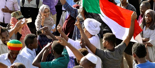 Sudanese demonstrators celebrate after Defence Minister Awad Ibn Auf stepped down as head of the country's transitional ruling military council, as protesters demanded quicker political change, near the Defence Ministry in Khartoum, Sudan April 13, 2019 Sudanese demonstrators celebrate after Defence Minister Awad Ibn Auf stepped down as head of the country's transitional ruling military council, as protesters demanded quicker political change, near the Defence Ministry in Khartoum, Sudan April 13, 2019 - Sputnik International