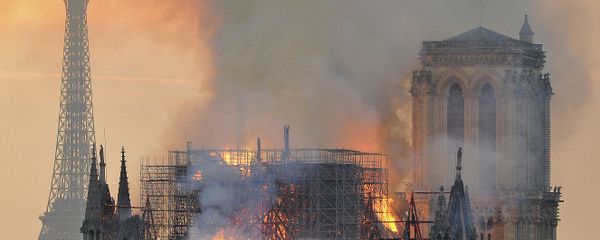 In this image made available on Tuesday April 16, 2019 flames and smoke rise from the blaze after the spire toppled over on Notre Dame cathedral in Paris, Monday, April 15, 2019 - Sputnik International