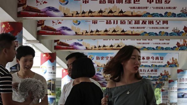 In this 29 June, 2018 photo, workers prepare to set up lights on the pillars displaying Chinese President Xi Jinping's signature China Dream and One Belt, One Road foreign policy plan during an event in Beijing - Sputnik International