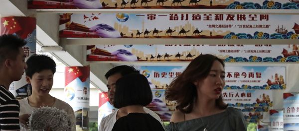 In this 29 June, 2018 photo, workers prepare to set up lights on the pillars displaying Chinese President Xi Jinping's signature China Dream and One Belt, One Road foreign policy plan during an event in Beijing In this 29 June, 2018 photo, workers prepare to set up lights on the pillars displaying Chinese President Xi Jinping's signature China Dream and One Belt, One Road foreign policy plan during an event in Beijing - Sputnik International