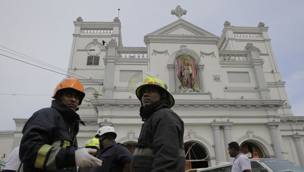 Sri Lankan firefighters stand in the area around St. Anthony's Shrine after a blast in Colombo, Sri Lanka, Sunday, April 21, 2019. - Sputnik International